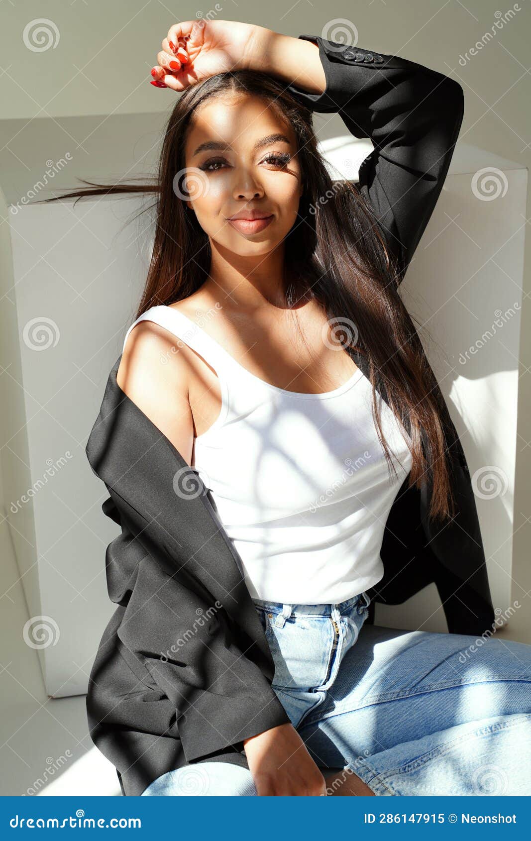 Cheerful Young Woman in Casual Outfit, in White Tank Top, Jeans and Black  Jacket, Posing in Studio, Looking at the Camera Stock Image - Image of  model, casual: 286147915