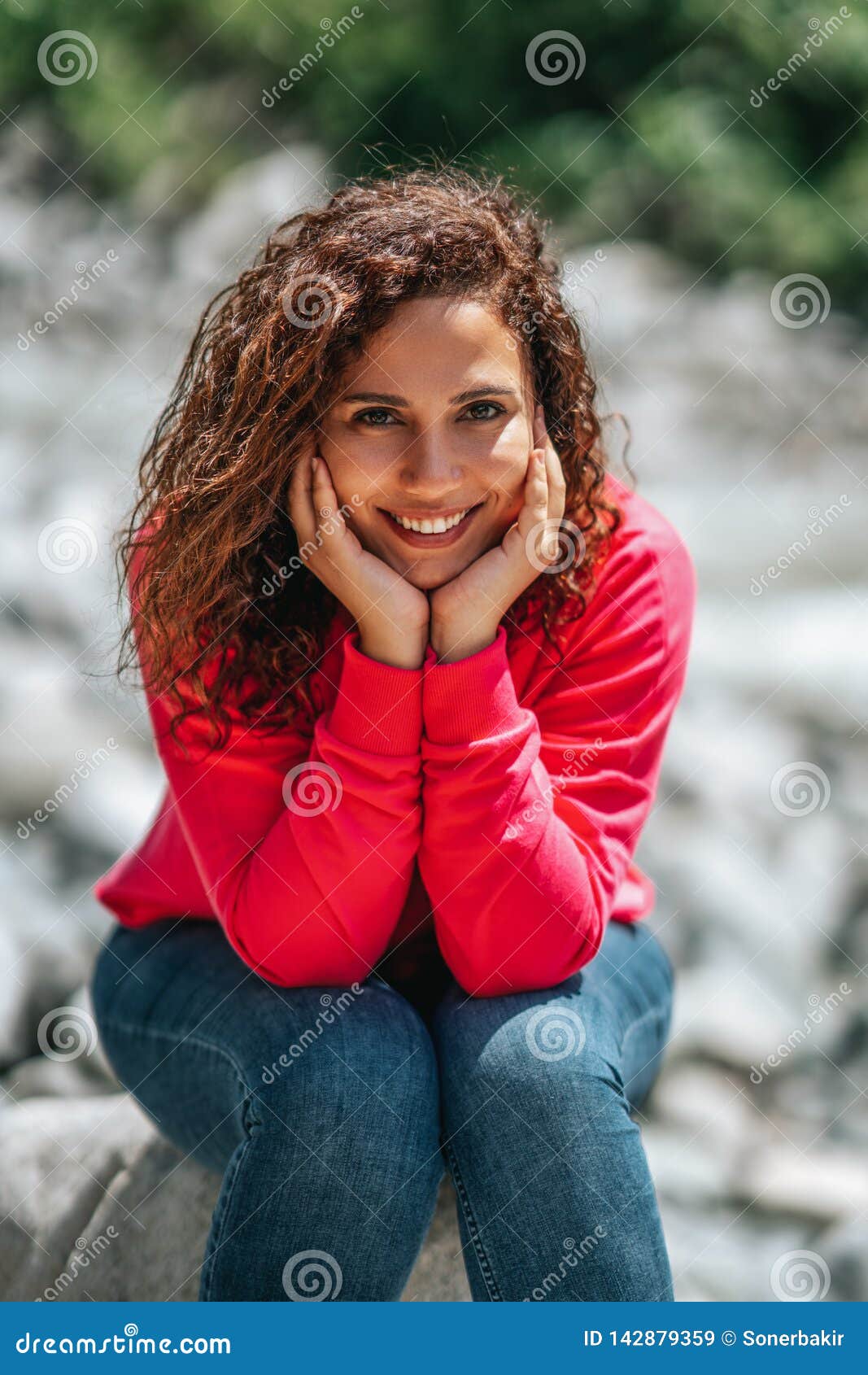 Laughing woman with curly hair posing in studio  attractive touching hair   Stock Photo  182403562