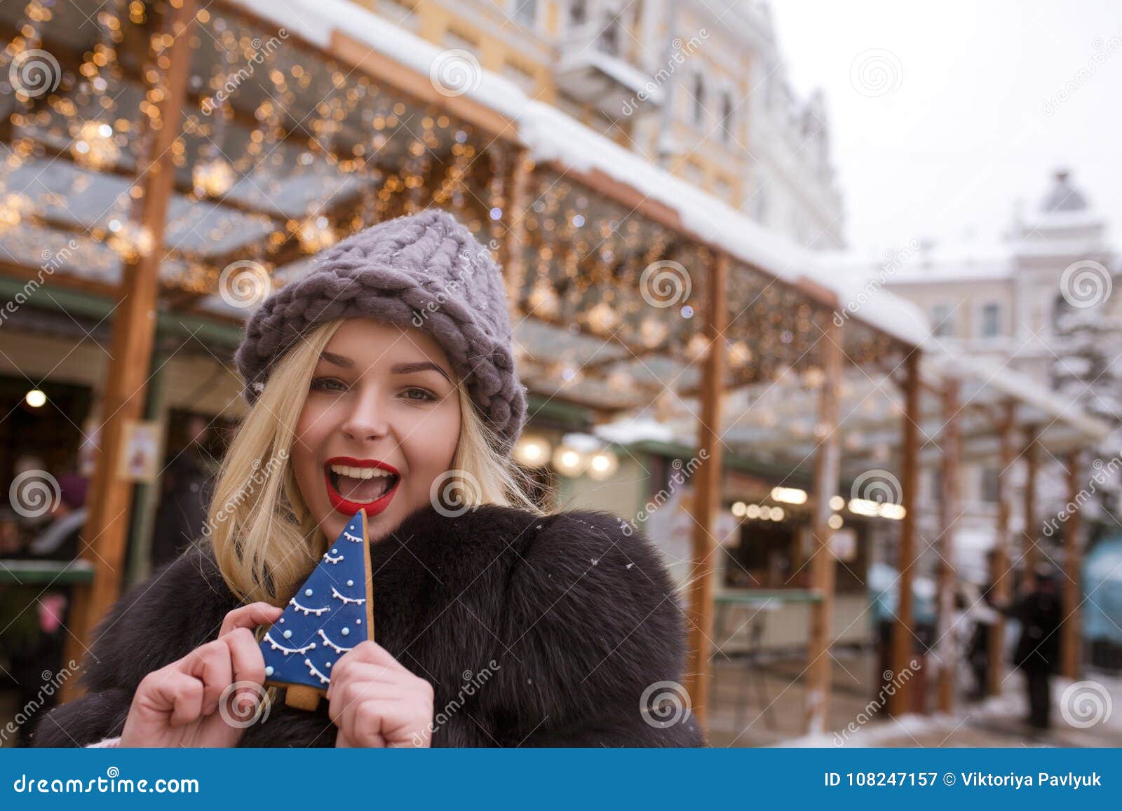 Cheerful Blonde Woman Holding Savory Gingerbread Against Light D Stock ...