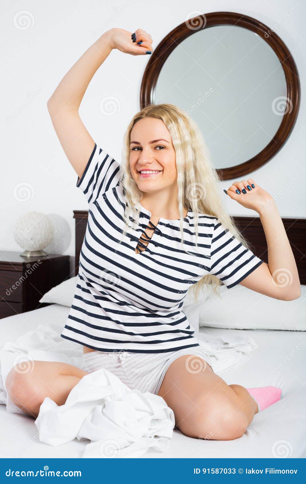 cheerful young woman with long hair awaking