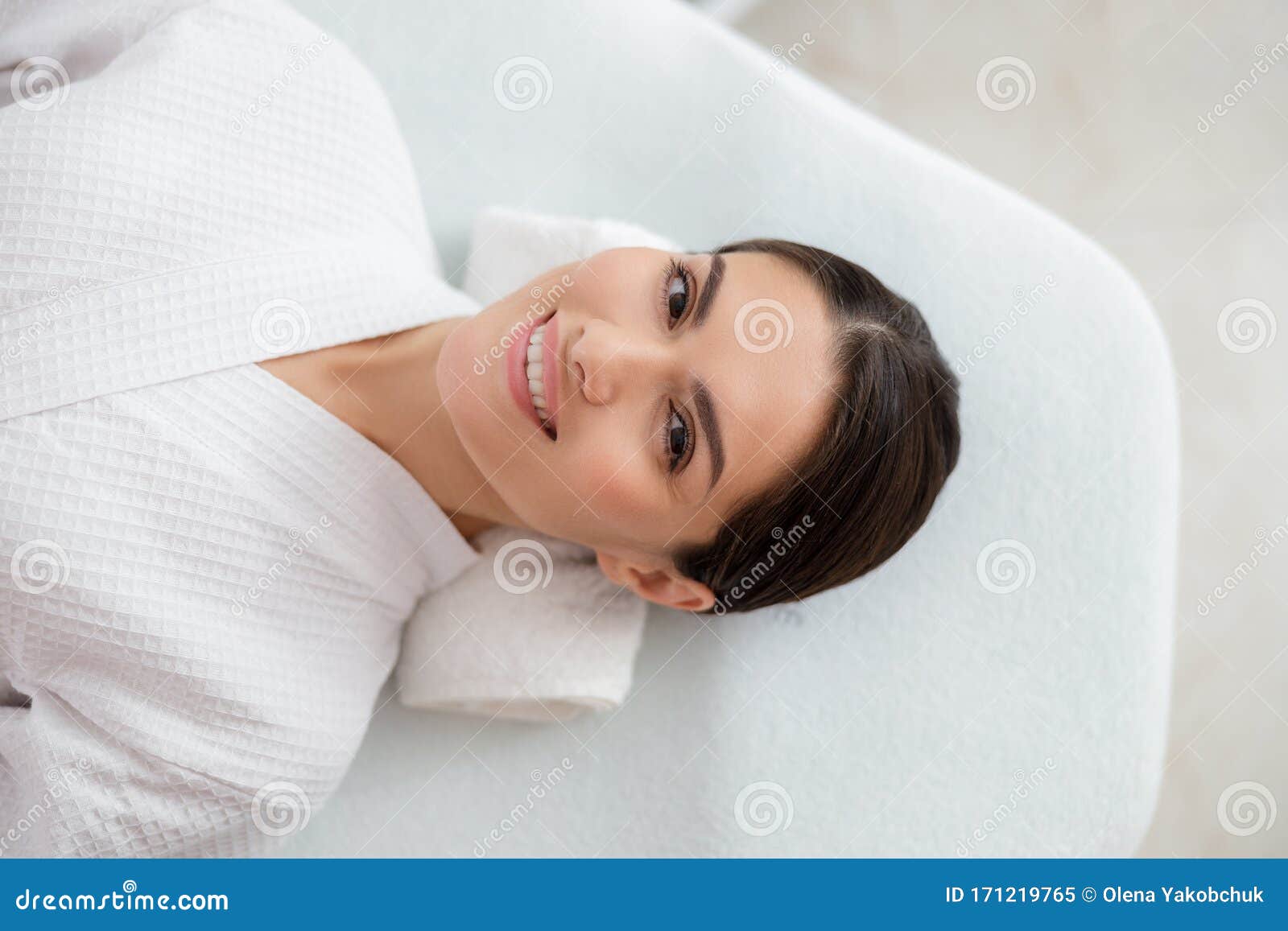Cheerful Young Woman Lying On Daybed At Beauty Salon Stock Image