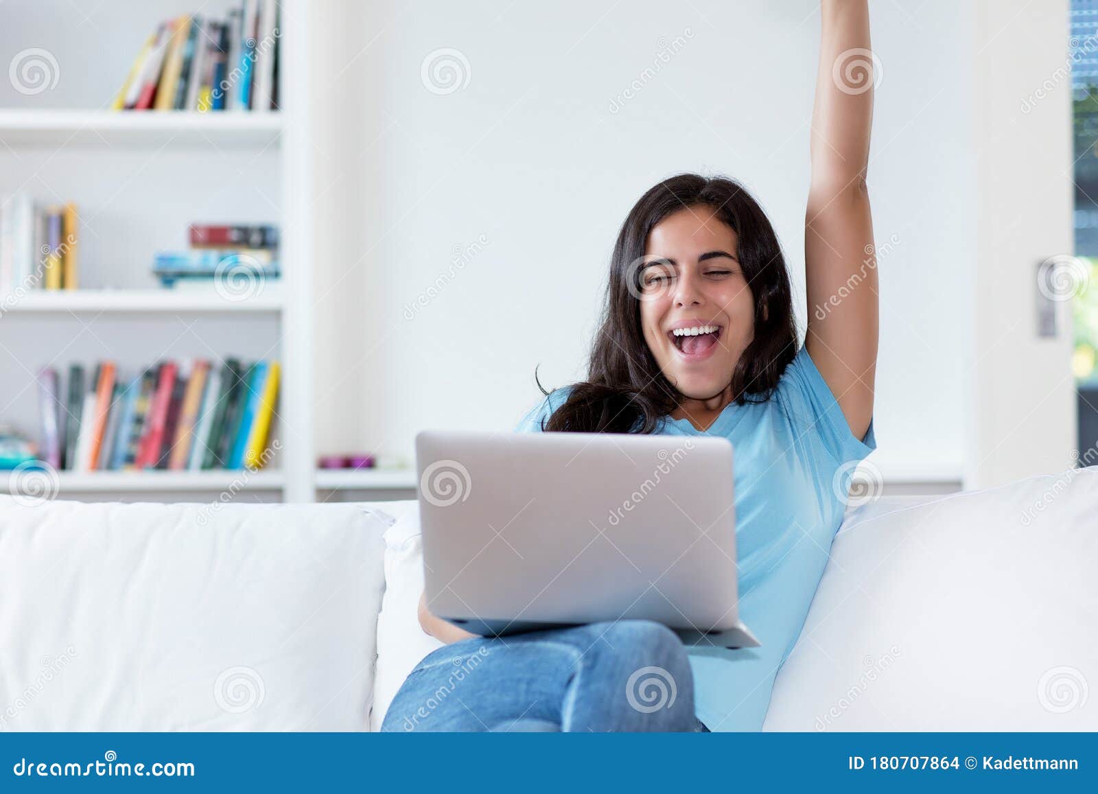 cheering indian woman in quarantine at computer