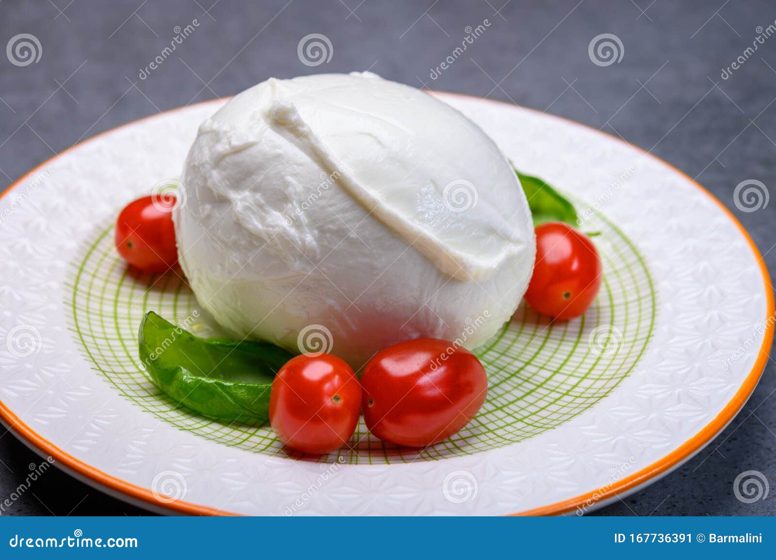 cheese collection, soft white italian mozzarella di bufala campana with fresh green basil leaves and red cherry tomatoes