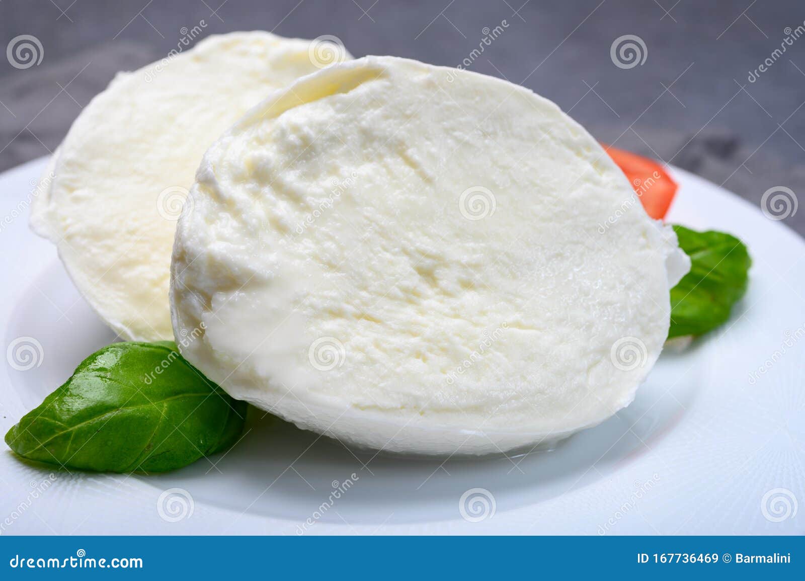 cheese collection, soft white italian mozzarella di bufala campana with fresh green basil leaves and red tomatoes
