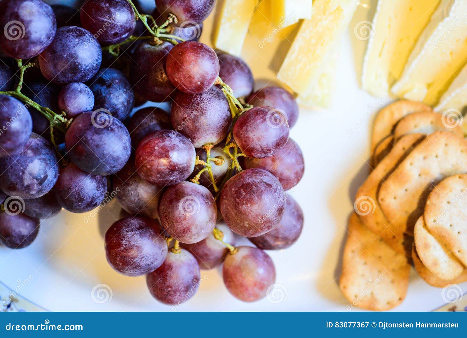 Cheese and grapes on plate stock image. Image of grape 83077367