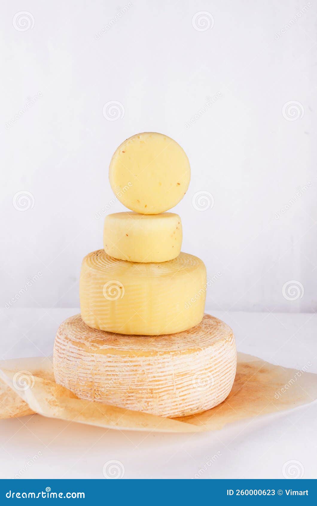 Cheese Heads of Different Kinds Stacked on Table Stock Image Image of