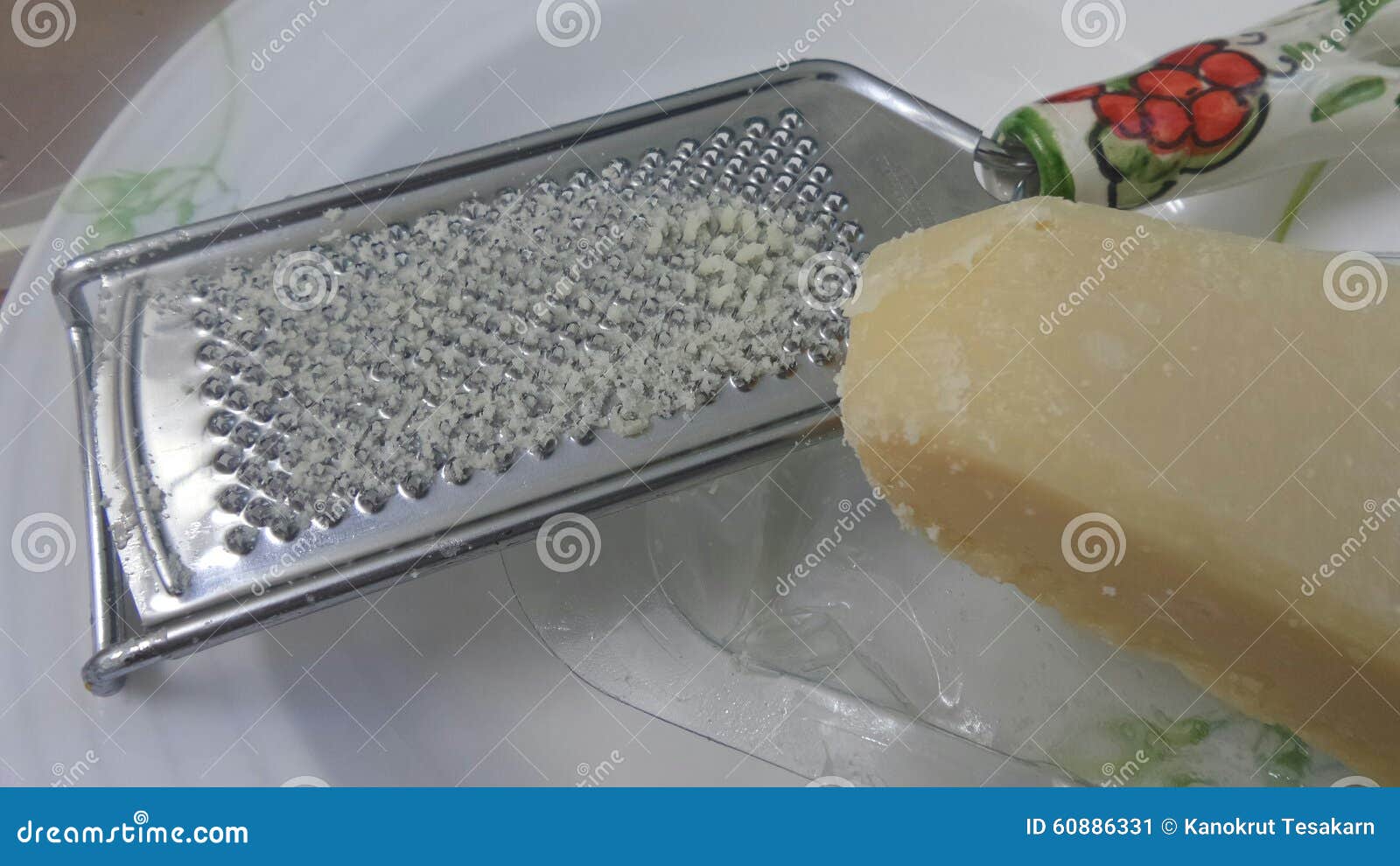 Cheese and Painted Grater in White Salad Bowl in the Kitchen Stock