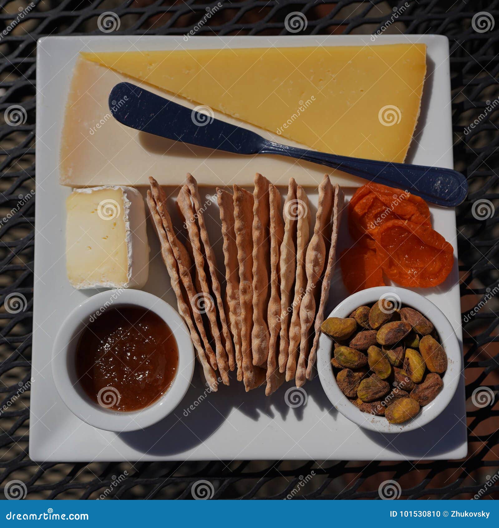 cheese plate with crackers and nuts