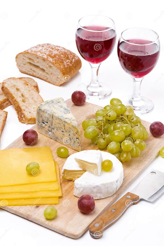 Cheese Platter, Grapes, Bread and Red Wine on a Wooden Board Stock