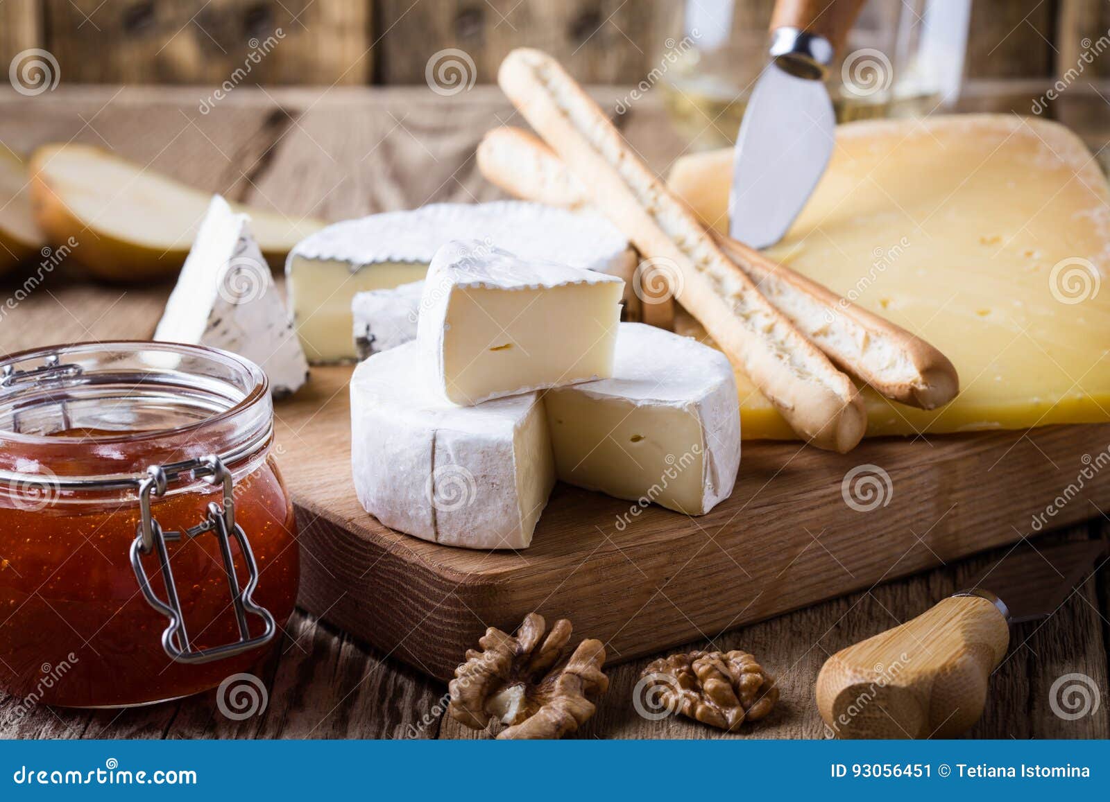 Cheese Platter with Wine, Jam and Walnuts on Wooden Board Stock Image