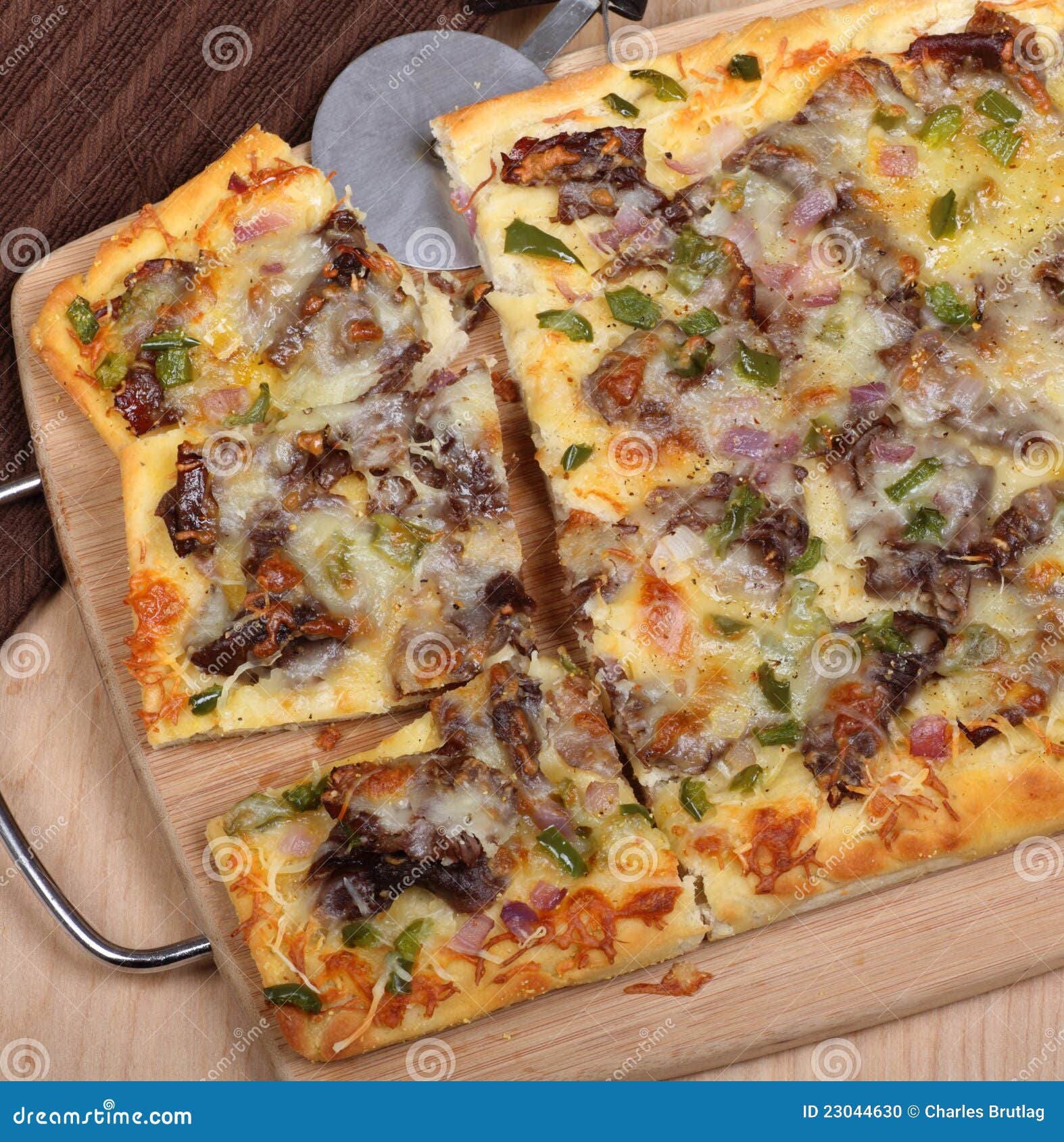 Cheese Steak Pizza Slices. Cheese steak pizza sliced on a tray