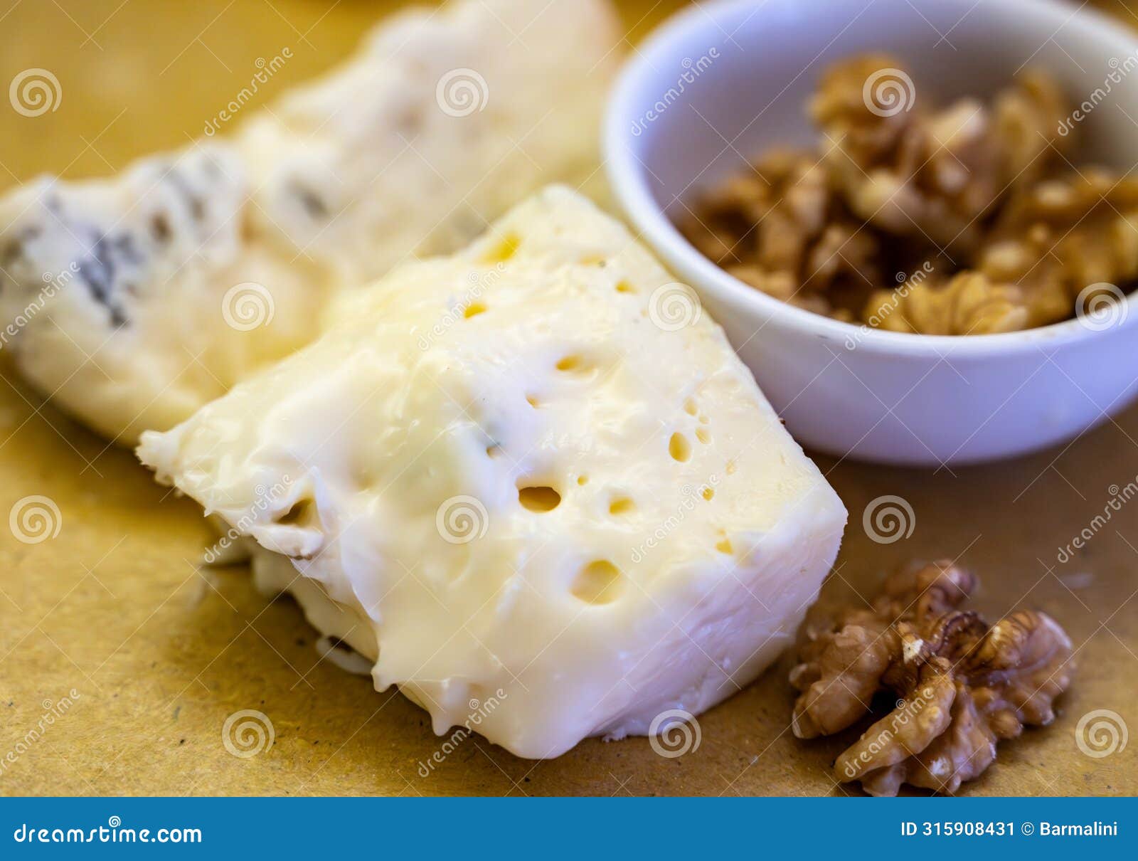 cheese tasting, piece of italian blue cheeses gorgonzola dolce and picante with blue mold from north of italy close up