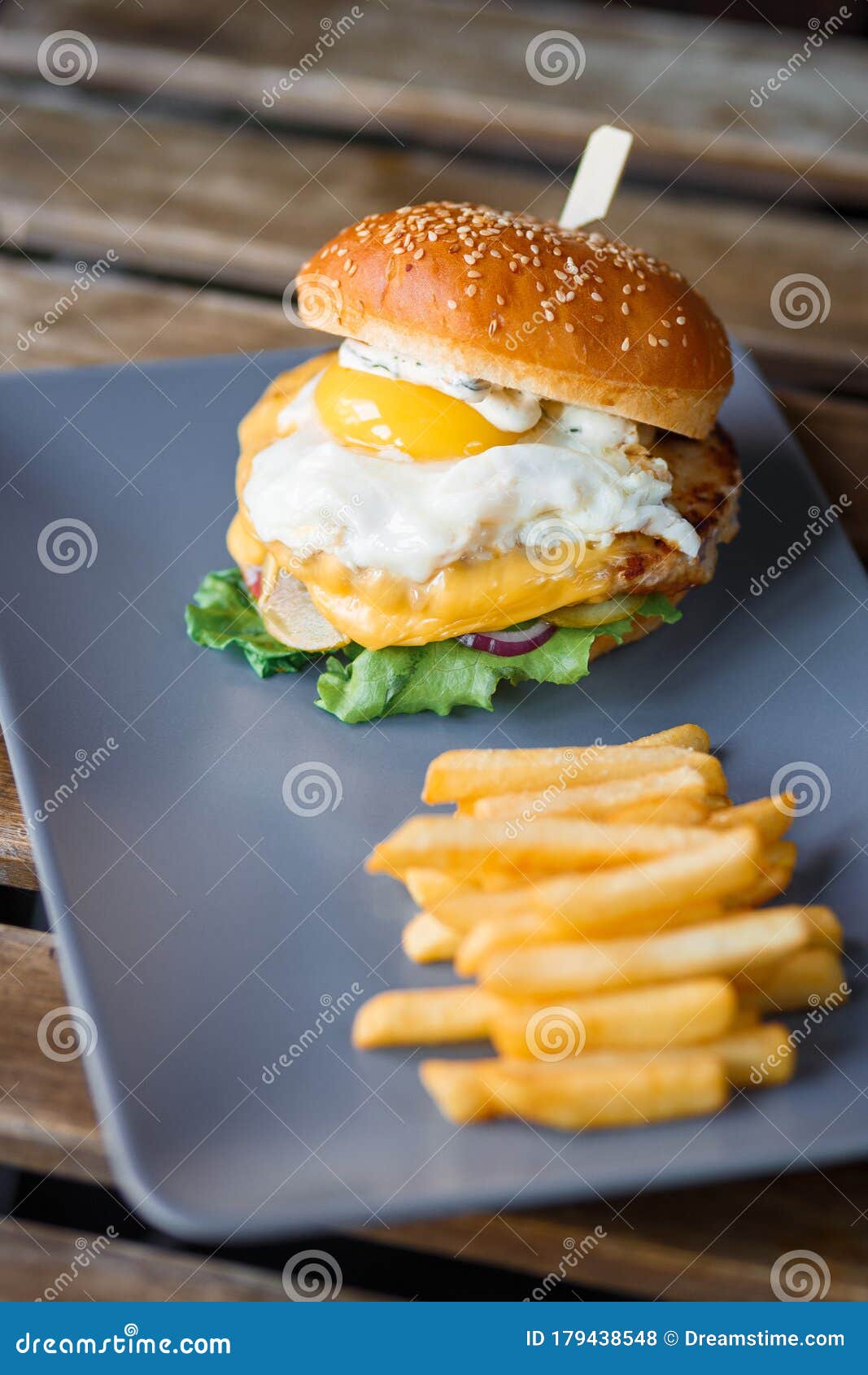 Cheeseburger with Egg on a Grey Ceramic Plate with Potatoes Stock Photo ...