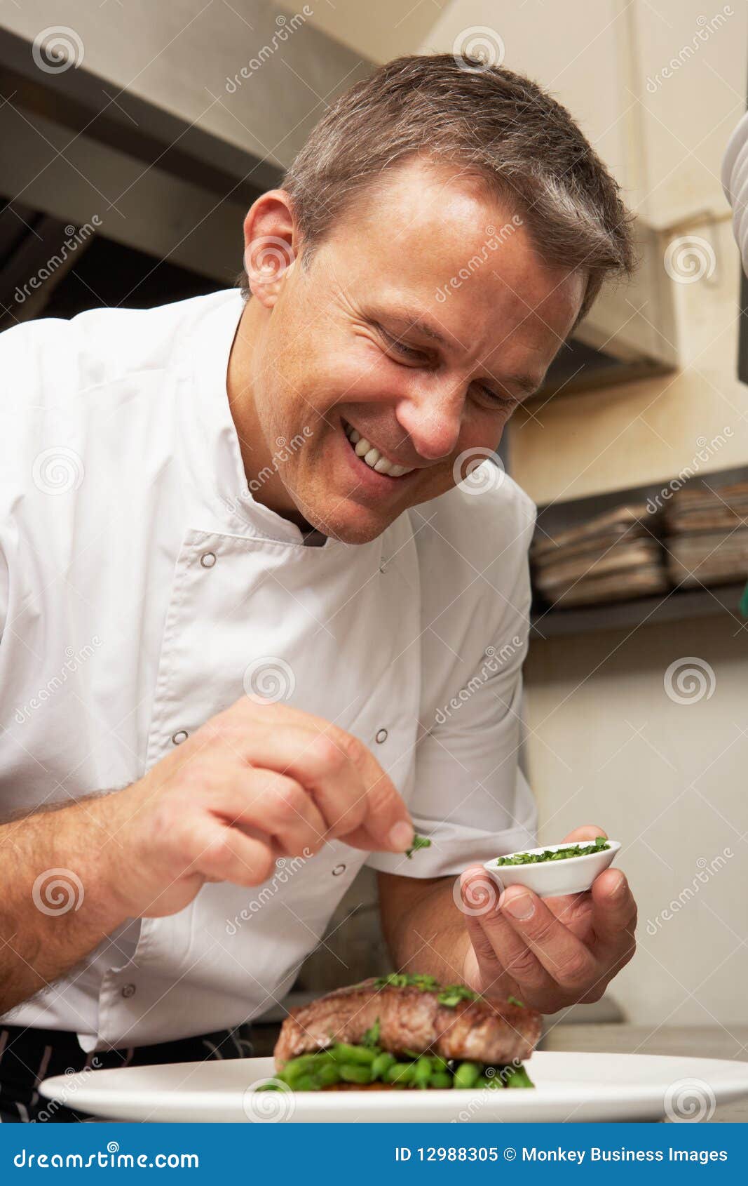 chef adding seasoning to dish in kitchen