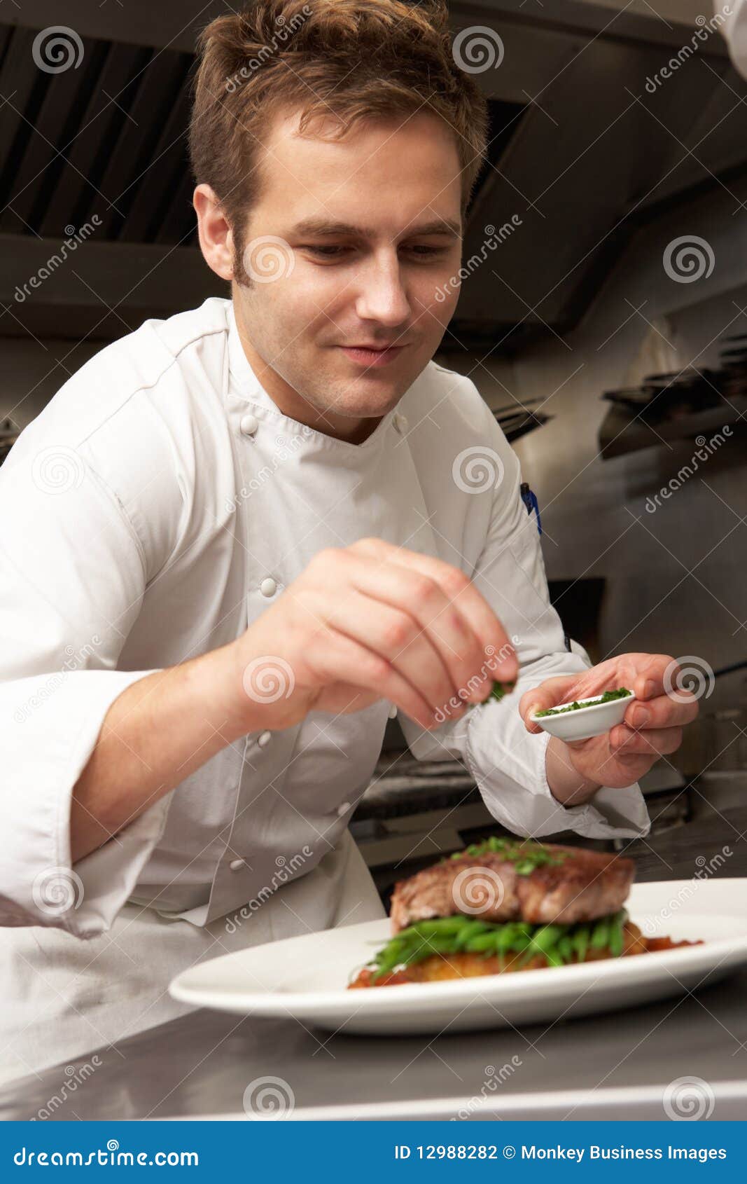 chef adding seasoning to dish in restaurant