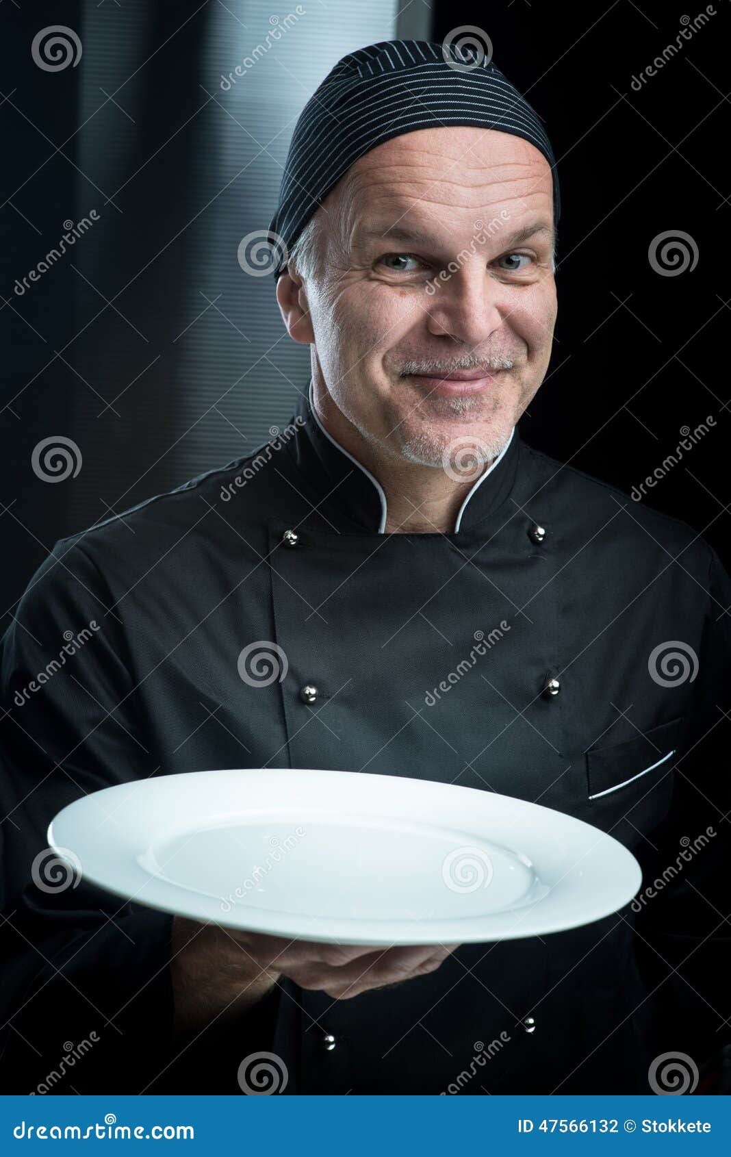 Chef in Black Uniform Showing a Plate Stock Photo Image of success, plate 47566132