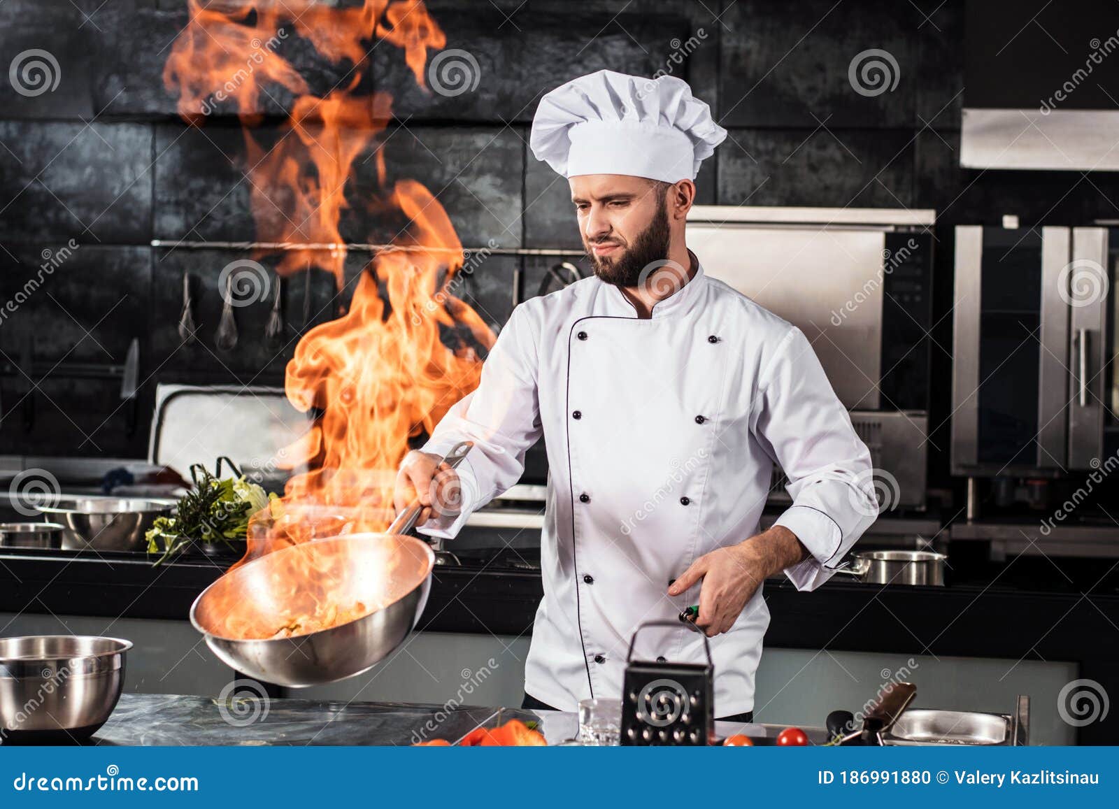 Chef Cook Food with Fire at Kitchen Restaurant. Cook with Wok at