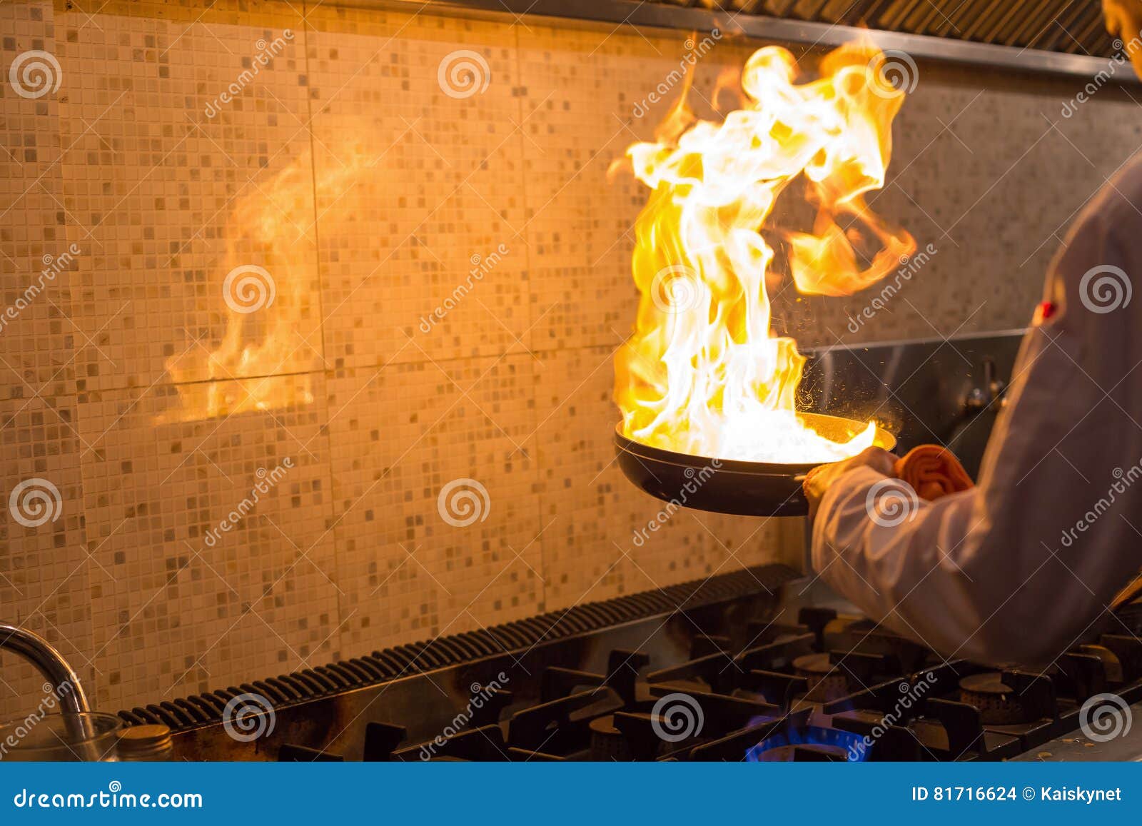 Chef cooking with flame. stock photo. Image of fried 81716624