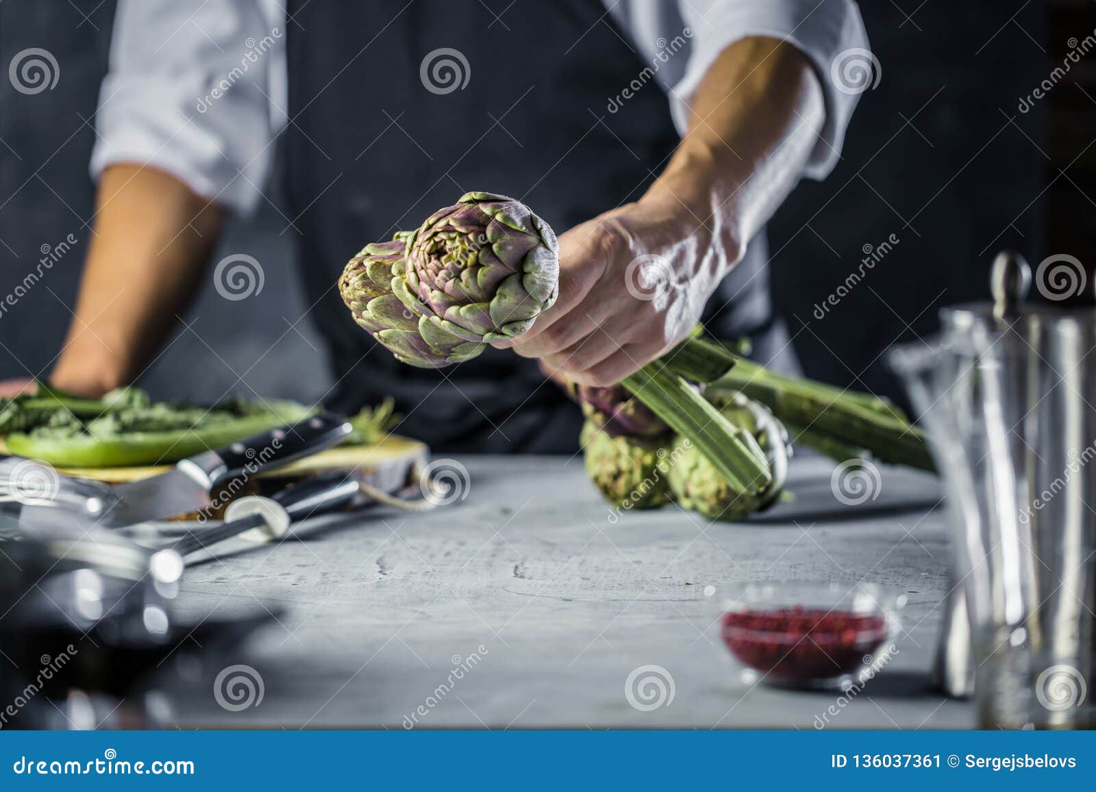 Chef Cutting Artichokes for Dinner Preparation Man Cooking Inside