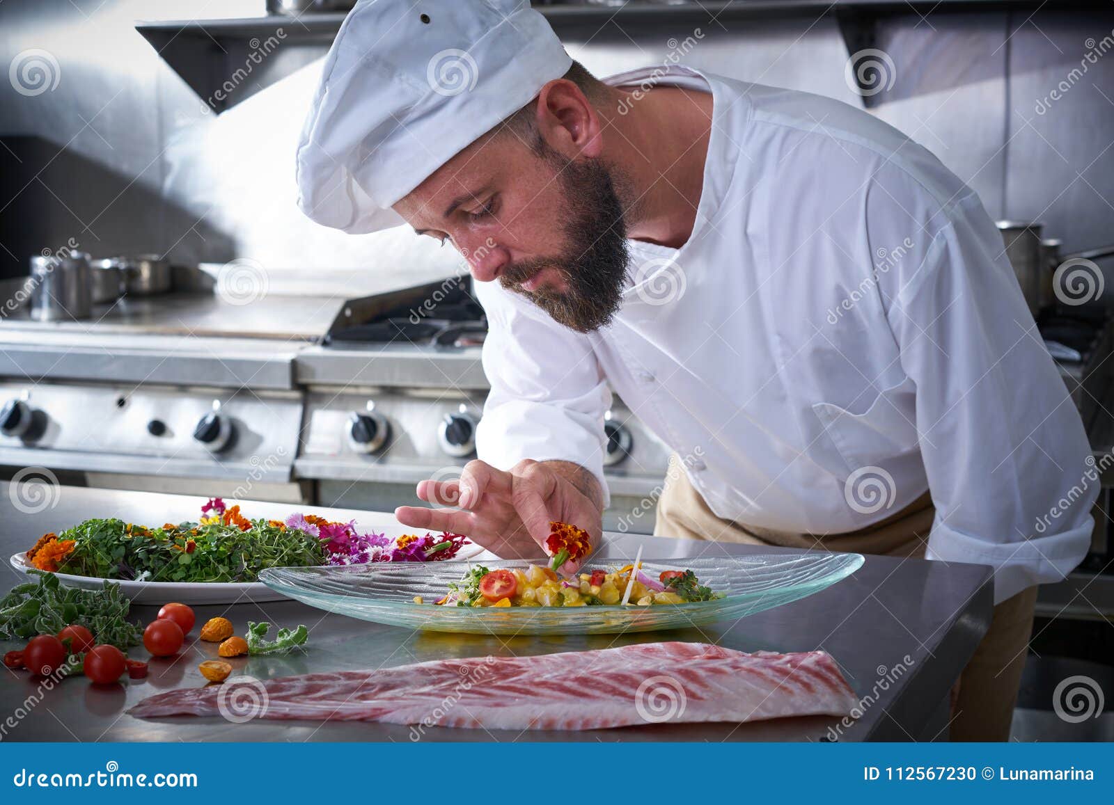 chef garnishing flower in ceviche dish