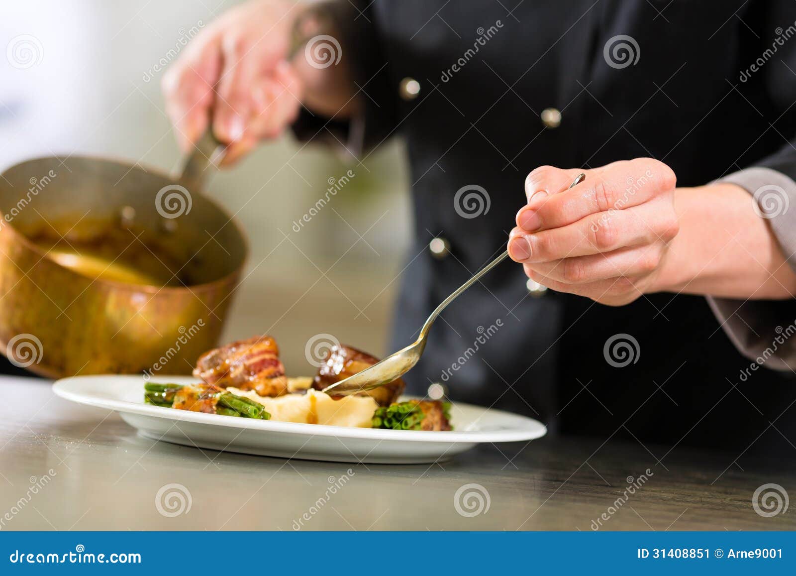 chef in hotel or restaurant kitchen cooking