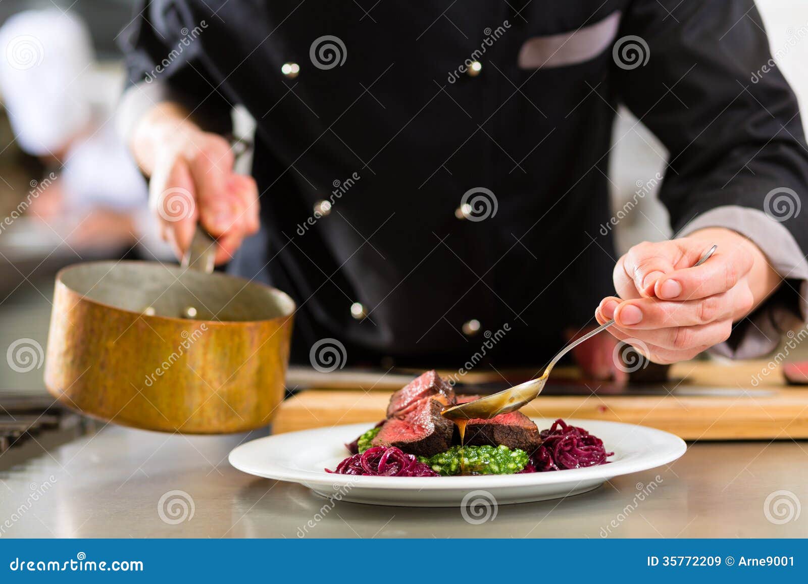 chef in hotel or restaurant kitchen cooking