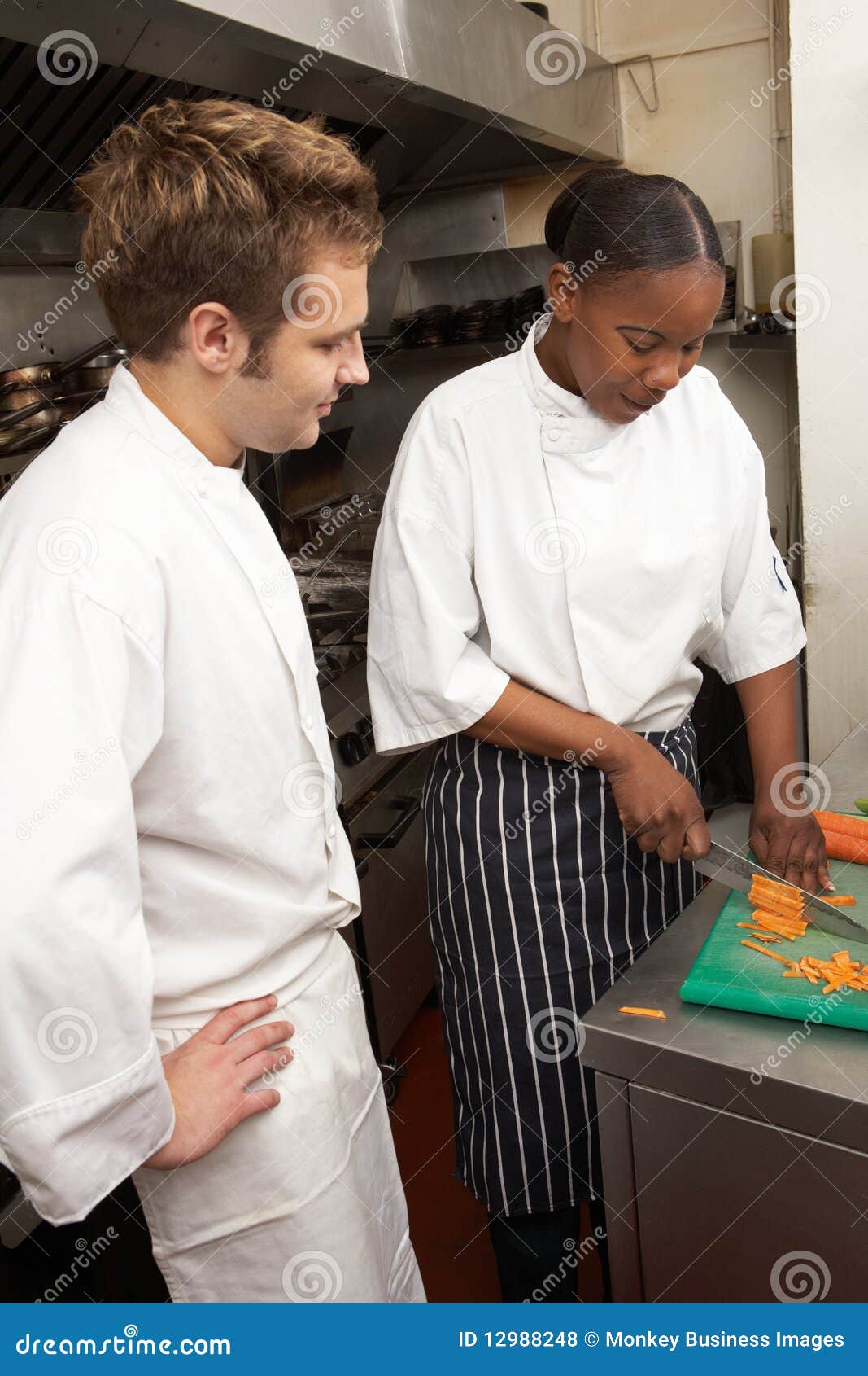 Chef Instructing Trainee in Restaurant Kitchen Stock Photo - Image of