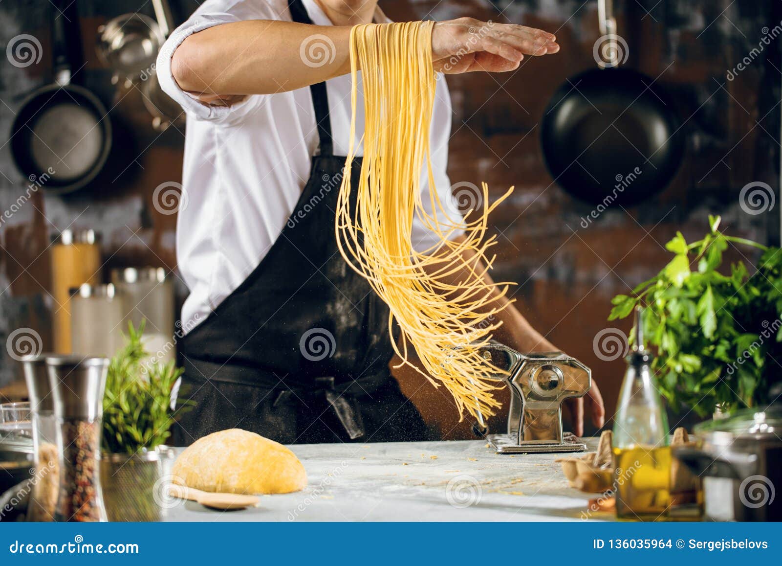 https://thumbs.dreamstime.com/z/chef-making-spaghetti-noodles-pasta-machine-kitchen-table-some-ingredients-around-136035964.jpg