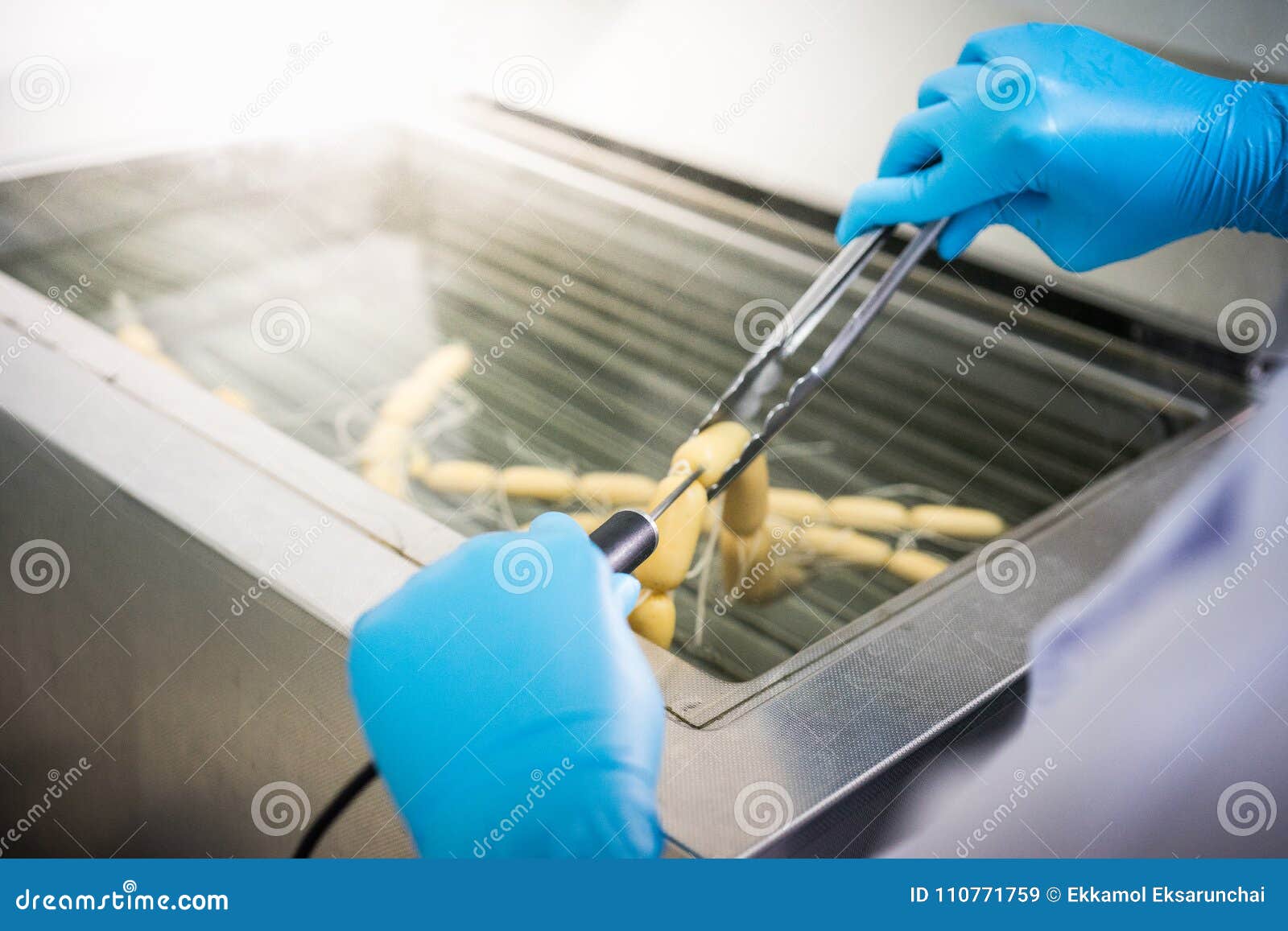 The Chef is Measuring the Temperature of the Sausage. Stock Image