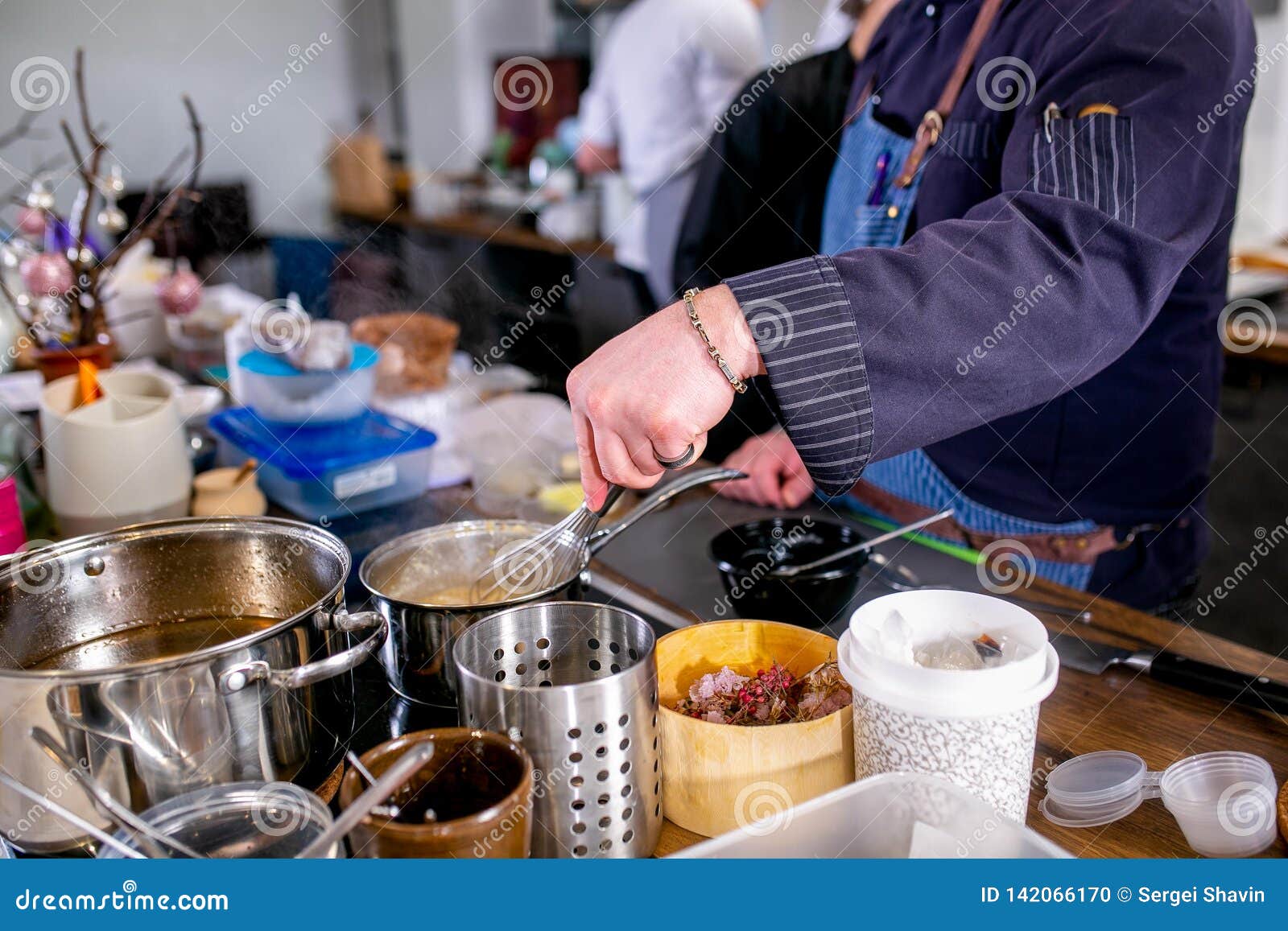 The Chef Mixes the Sauce in a Saucepan Using the Whisk. Master