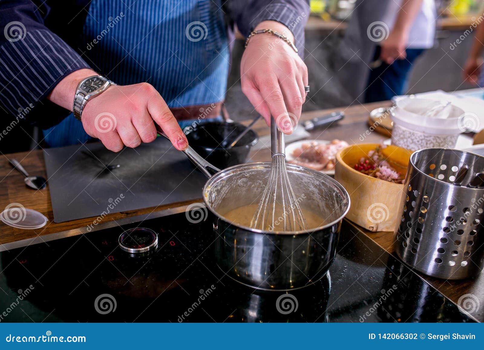 The Chef Mixes the Sauce in a Saucepan Using the Whisk. Master