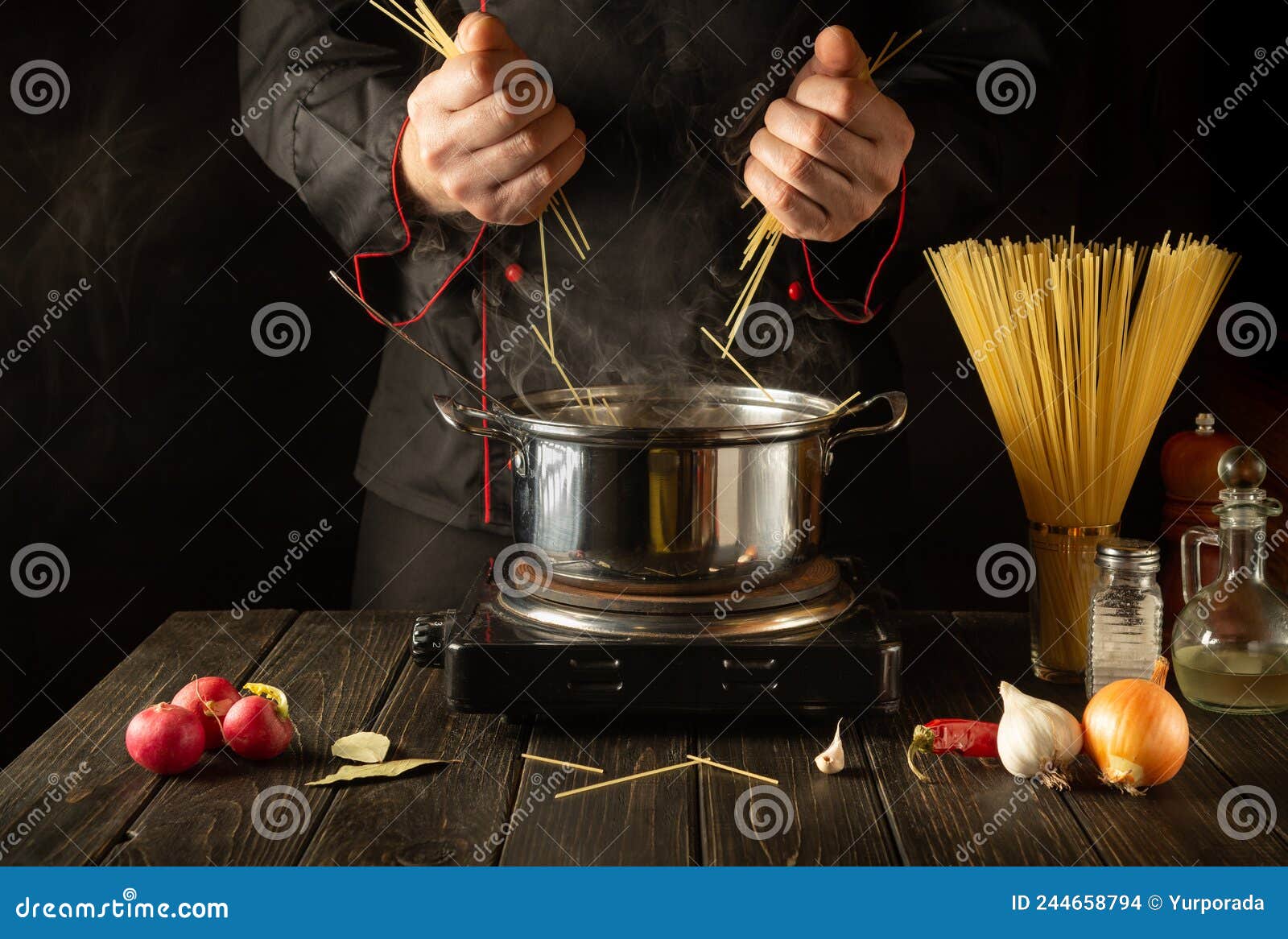 chef prepares italian pasta in a saucepan with vegetables. close-up of cook hands while cooking in kitchen. cucina italiana