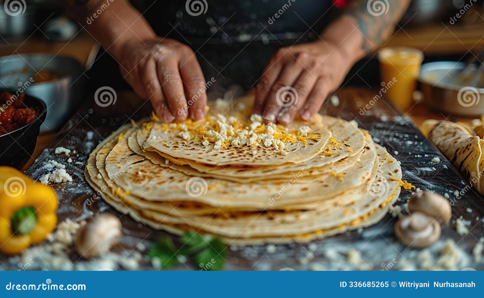 chef preparing layered dish with cheese and tortillas
