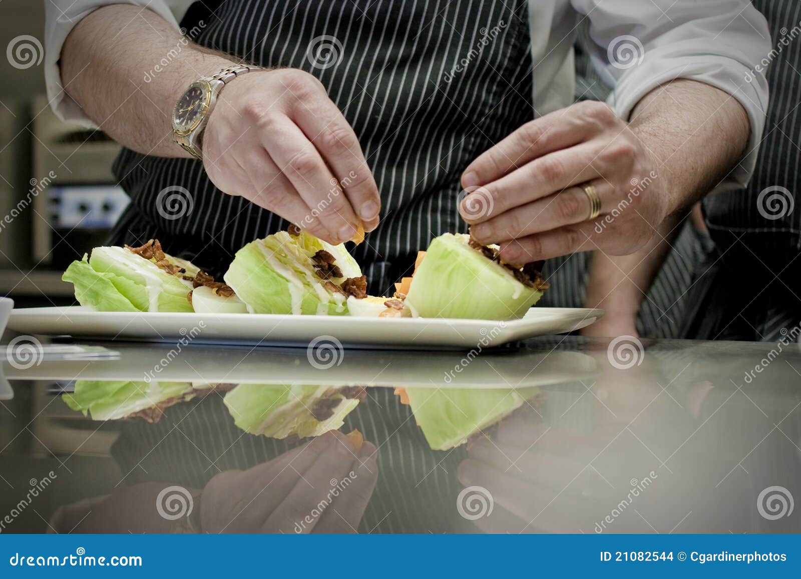Chef Preparing Salad. An image of a professional restaurant chef preparing a salad plate.