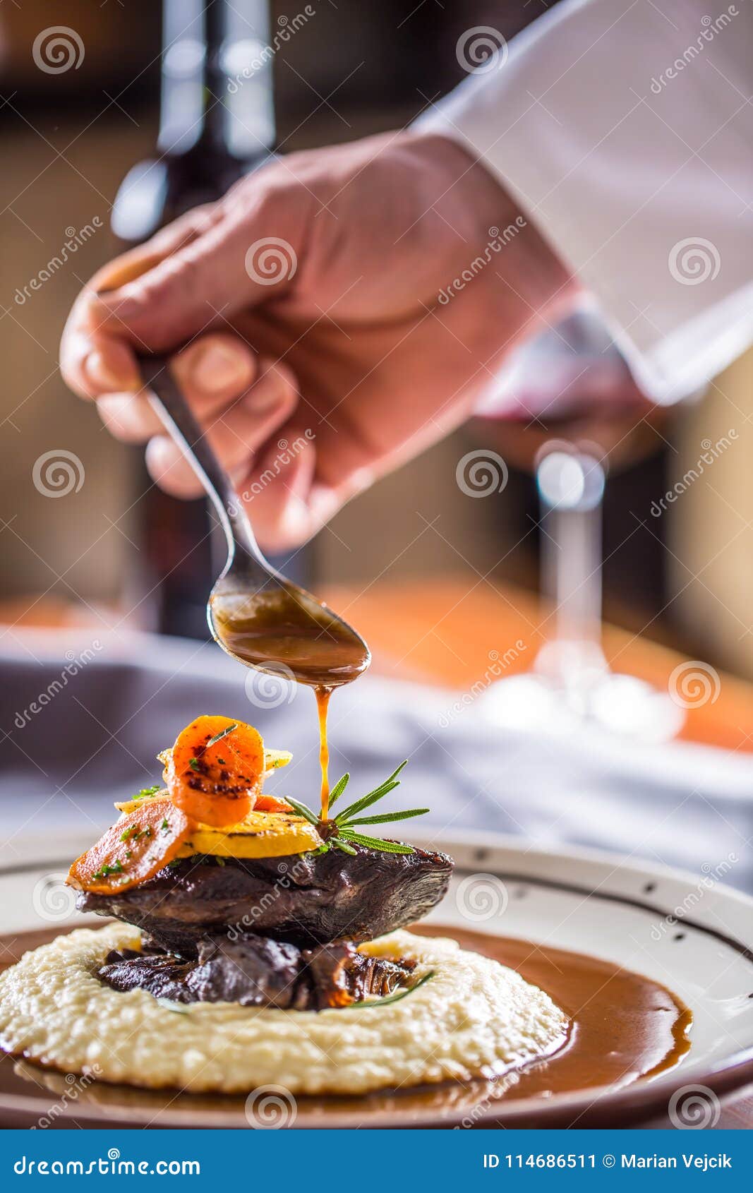 chef in pub or restaurant decorates portion of the meal in pup or restaurant