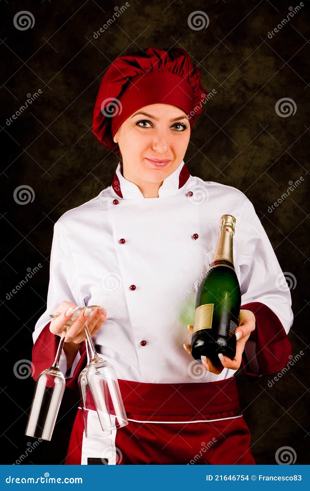 Chef Somelier - Christmas. Photo of young female chef with champagne bottle ready to open it