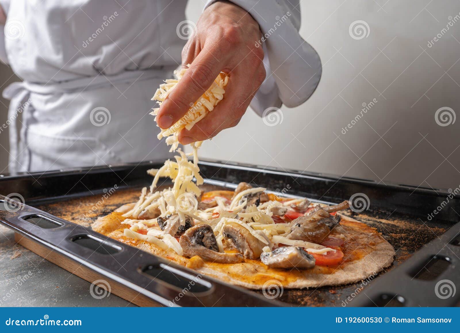 The Chef Sprinkles Cheese on the Vegetarian Pizza Stock Photo Image of kitchen, dinner 192600530