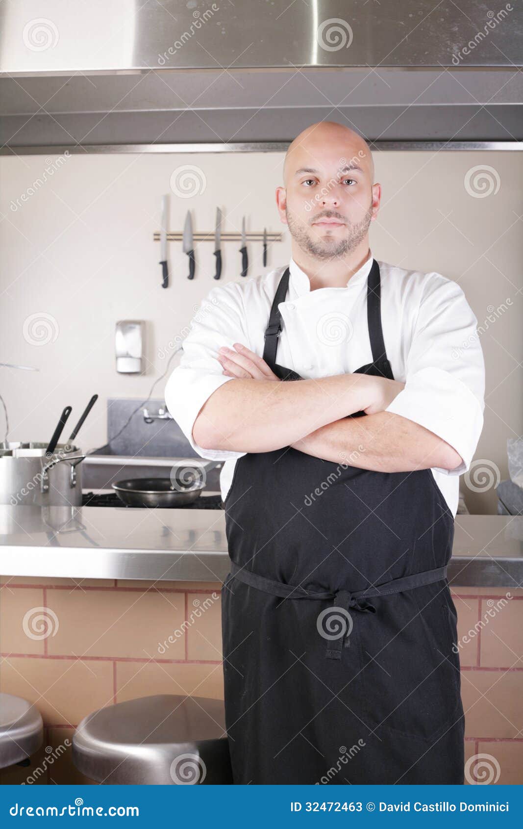 Male Chef Standing Next To Cooker In Kitchen