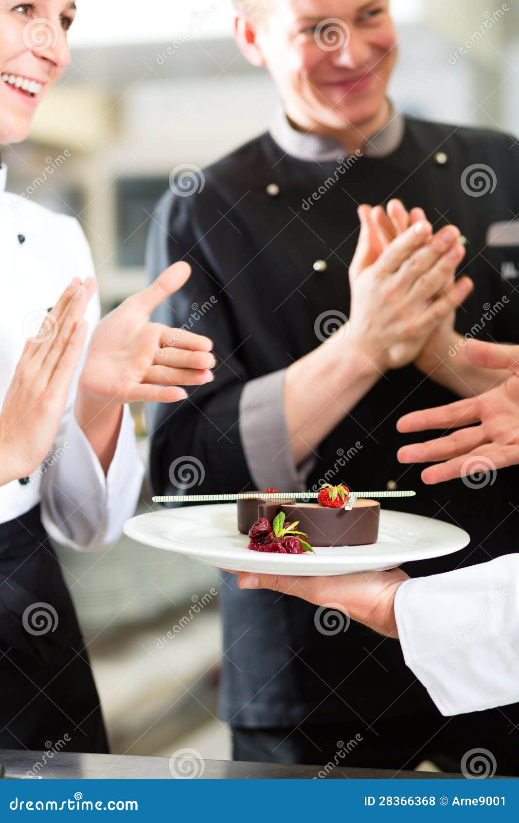 chef team in restaurant kitchen with dessert