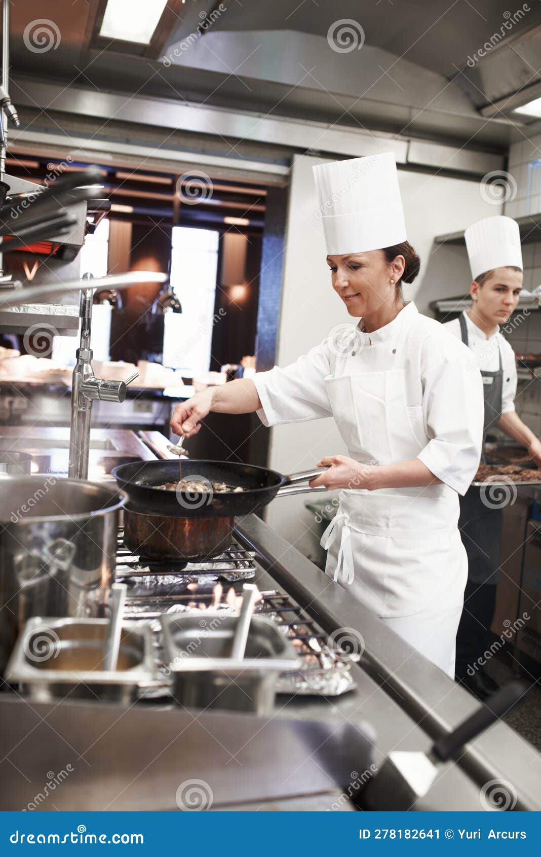 chef, woman and frying pan with sauce in kitchen, catering service and prepare food for restaurant fine dining