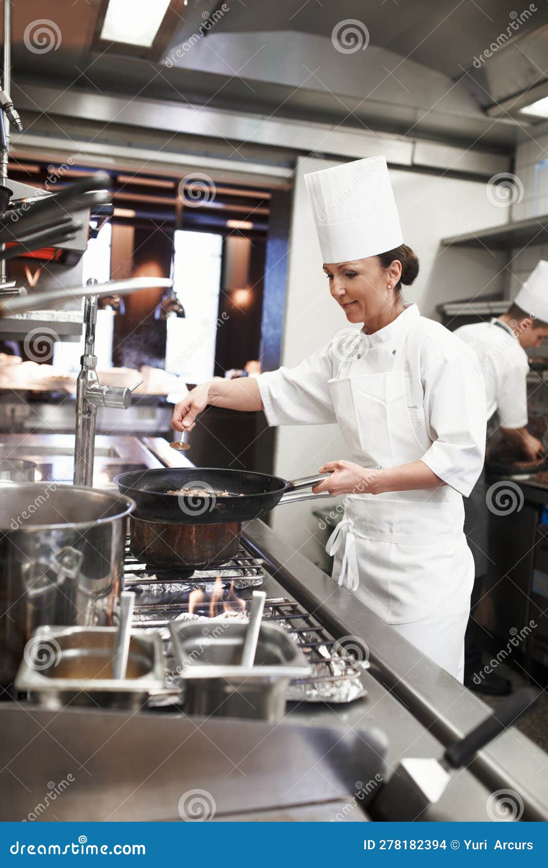 chef, woman and frying pan with sauce in restaurant kitchen, catering service and prepare food for fine dining