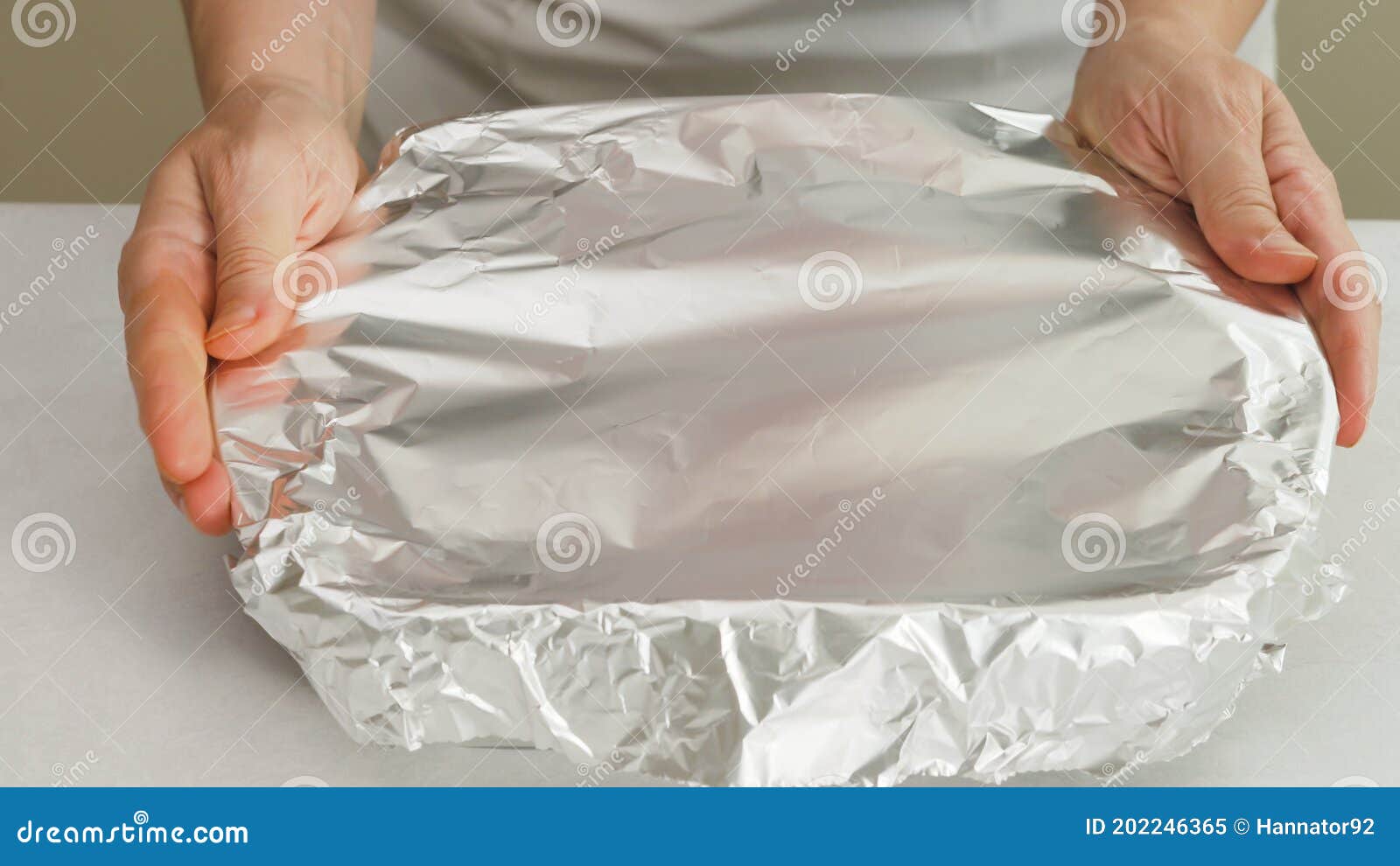 Chef Wraps Baking Pan with Aluminum Foil. Stock Image Image of