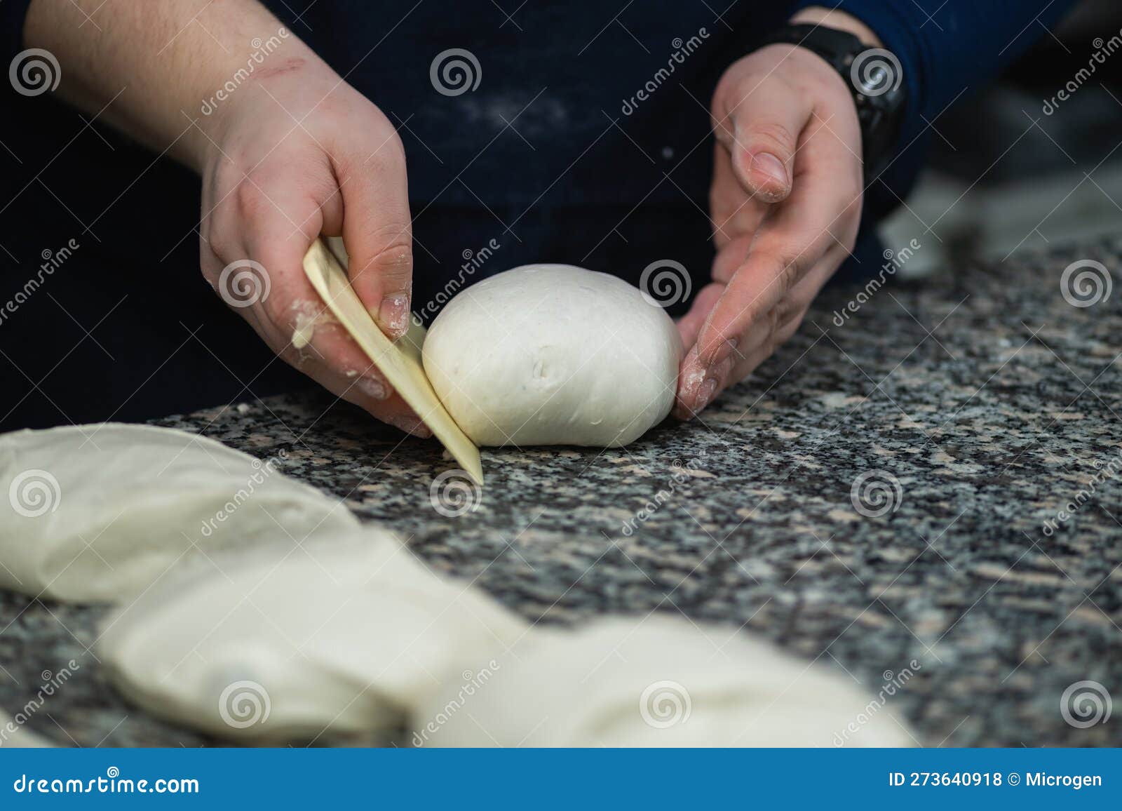 Chefs Hand Preparing Dough for Pizza in Restaurant Kitchen Stock Photo