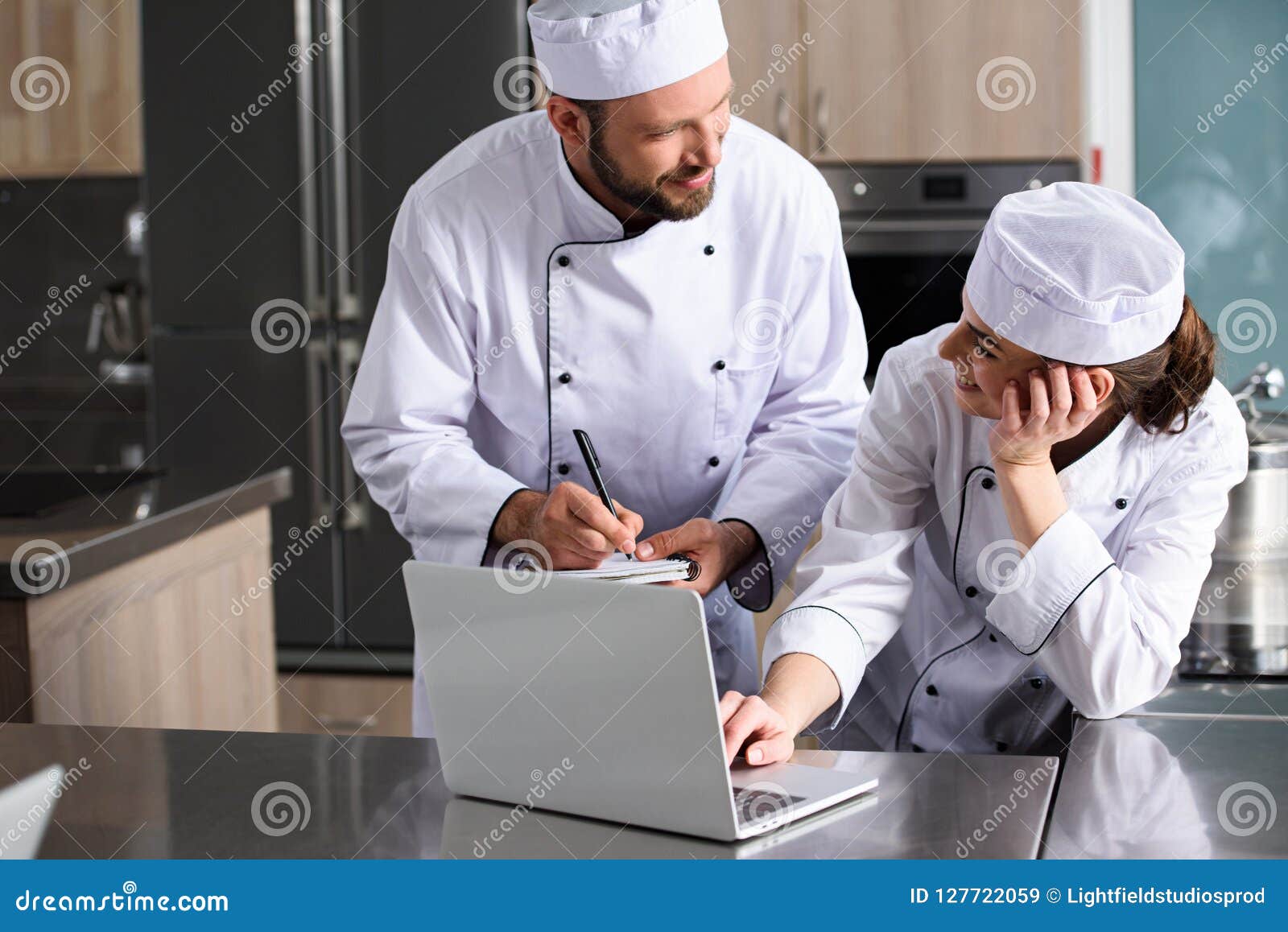Chefs Using Laptop at Restaurant Kitchen Stock Image Image of
