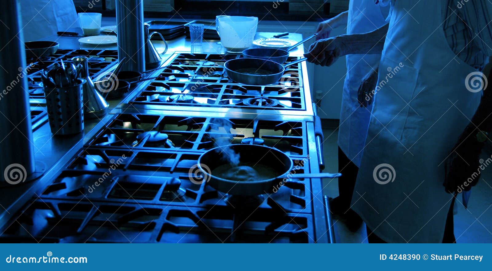 chefs working with frying pans