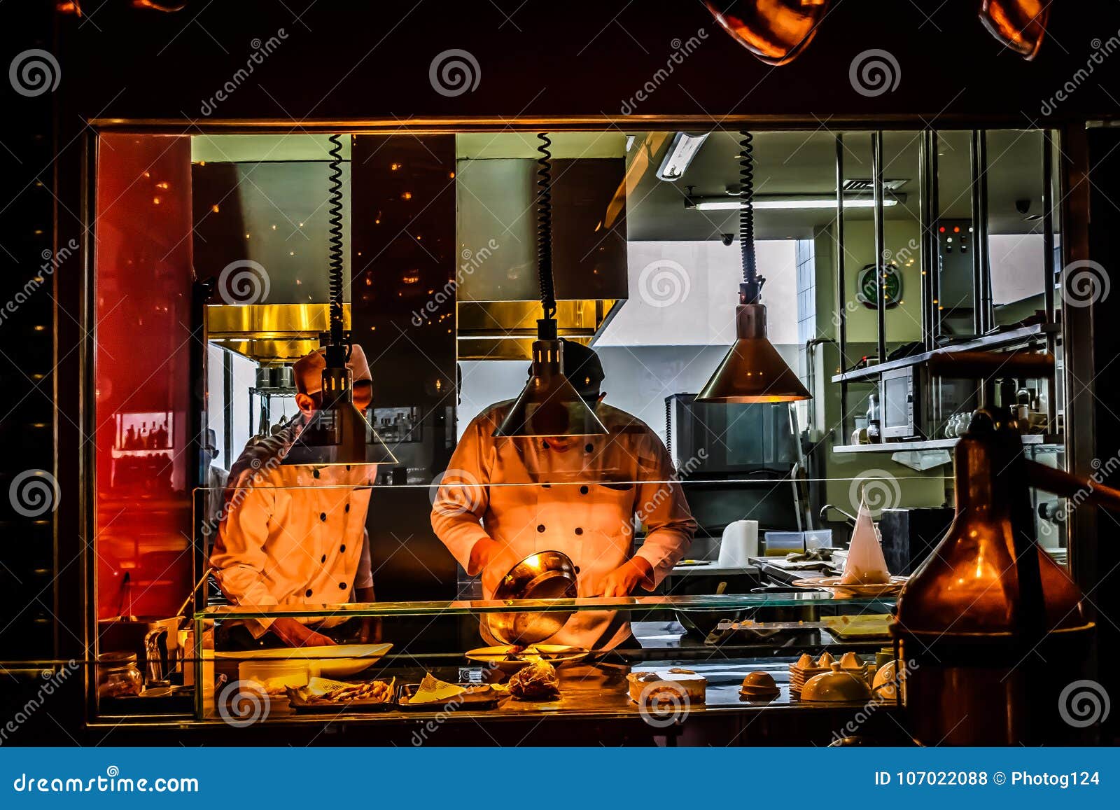 Chefs Working in Italian Restaurant Kitchen Editorial Stock Photo