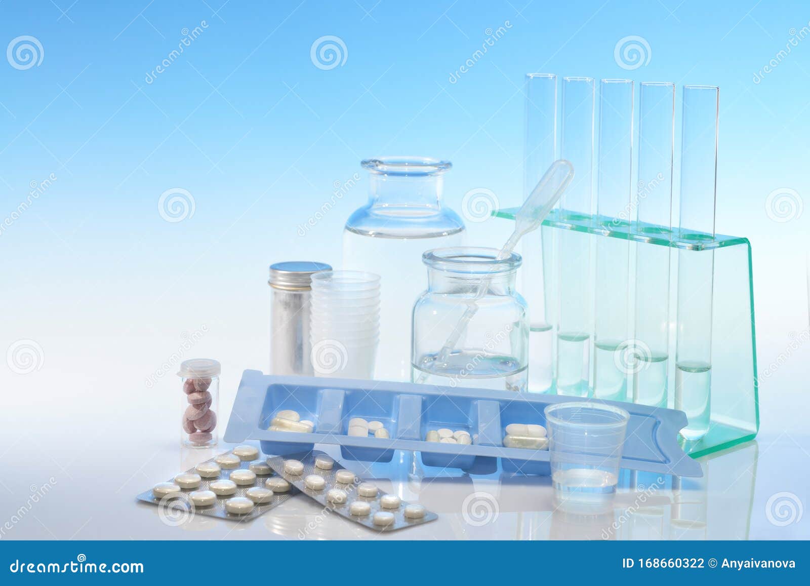 Chemical and Analytical Glassware and Various Pills on Blue Background
