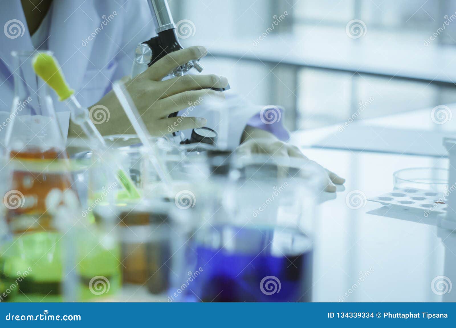 chemist, microscope, chemical testing in lab, concept for improving safety products before applying to consumers