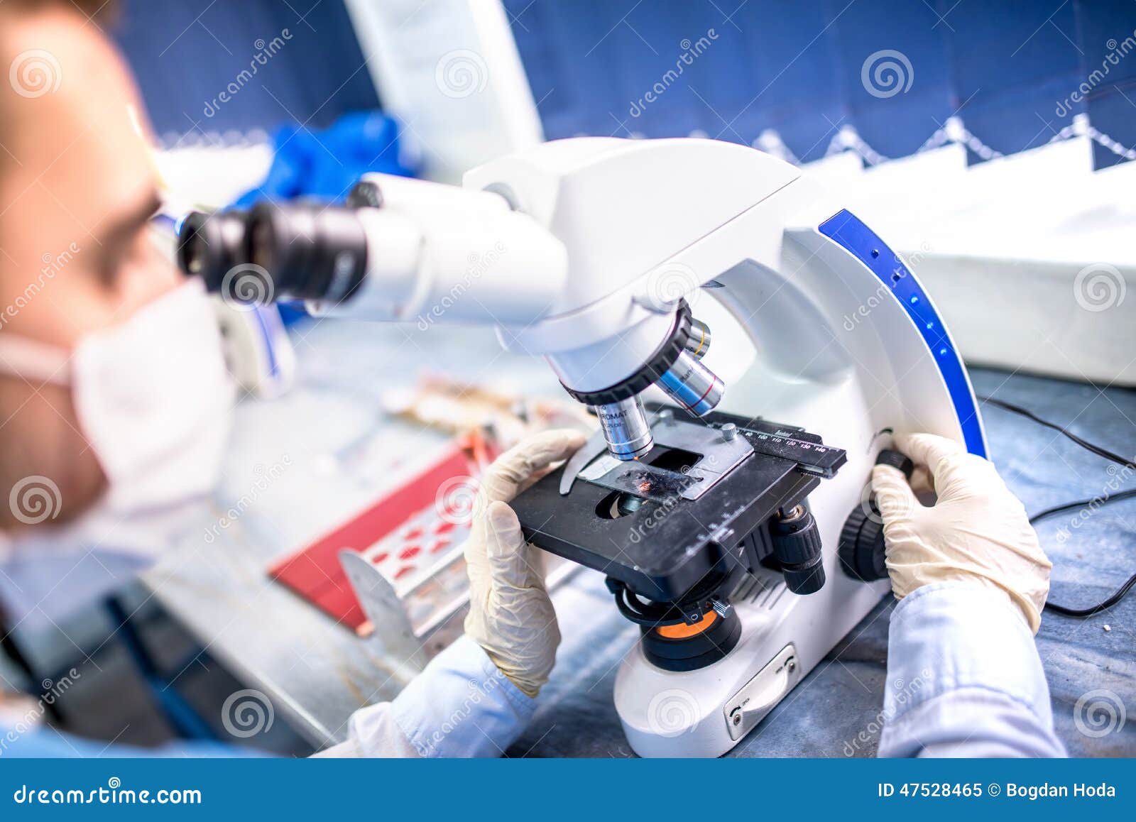 chemist researcher working with microscope for forensic evidence