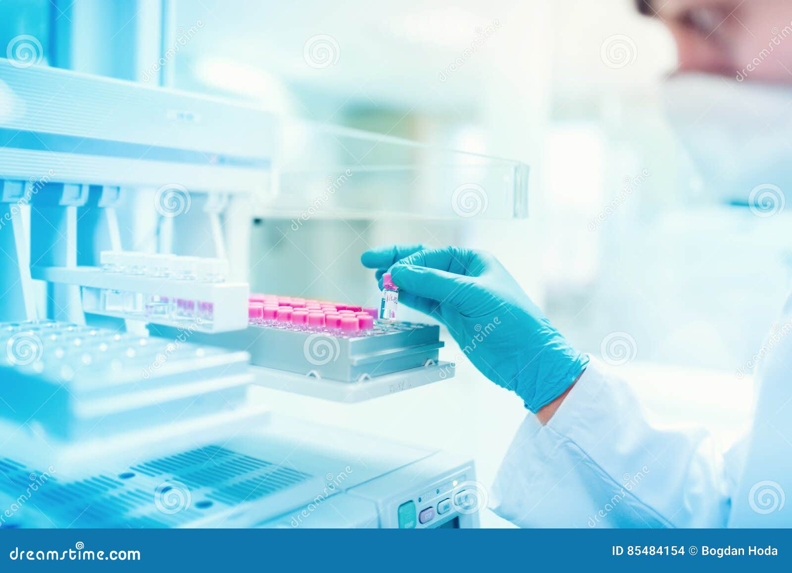 chemist scientist holding sample and examining test tube in special laboratory